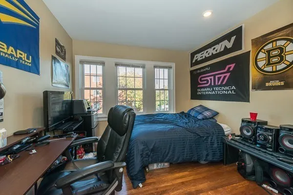 a bedroom with furniture and a flat screen tv