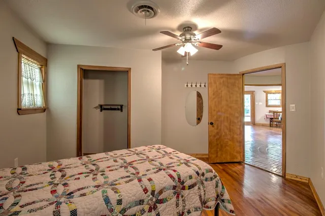 a bedroom with a bed and a chandelier