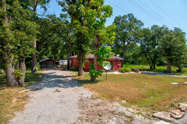 a view of a street with a large trees
