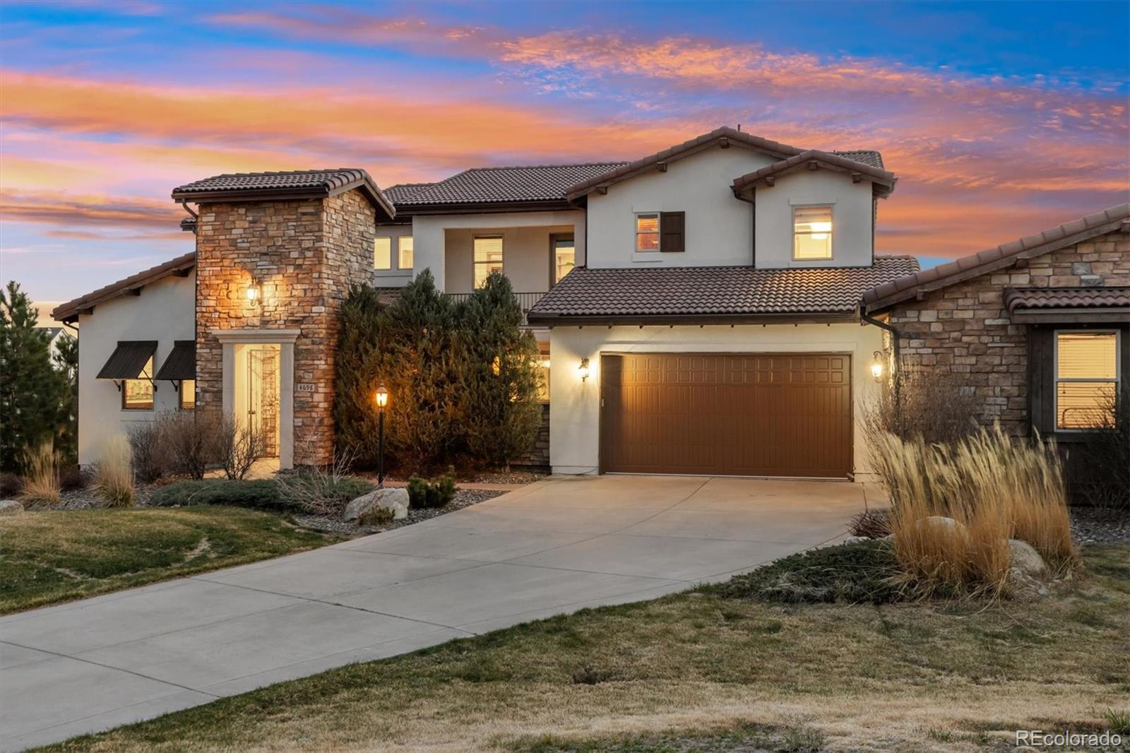 4698 Bandera Place Parker, CO 80134 - Photo 1 of 43 a front view of a house with a yard