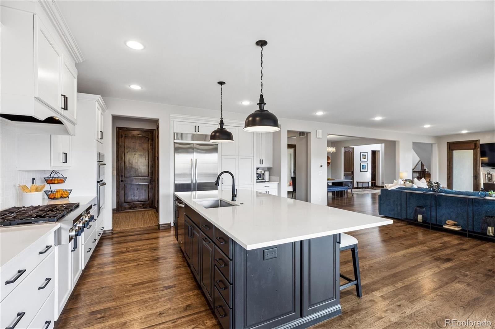 4698 Bandera Place Parker, CO 80134 - Photo 14 of 43 a large kitchen with kitchen island a large island in it