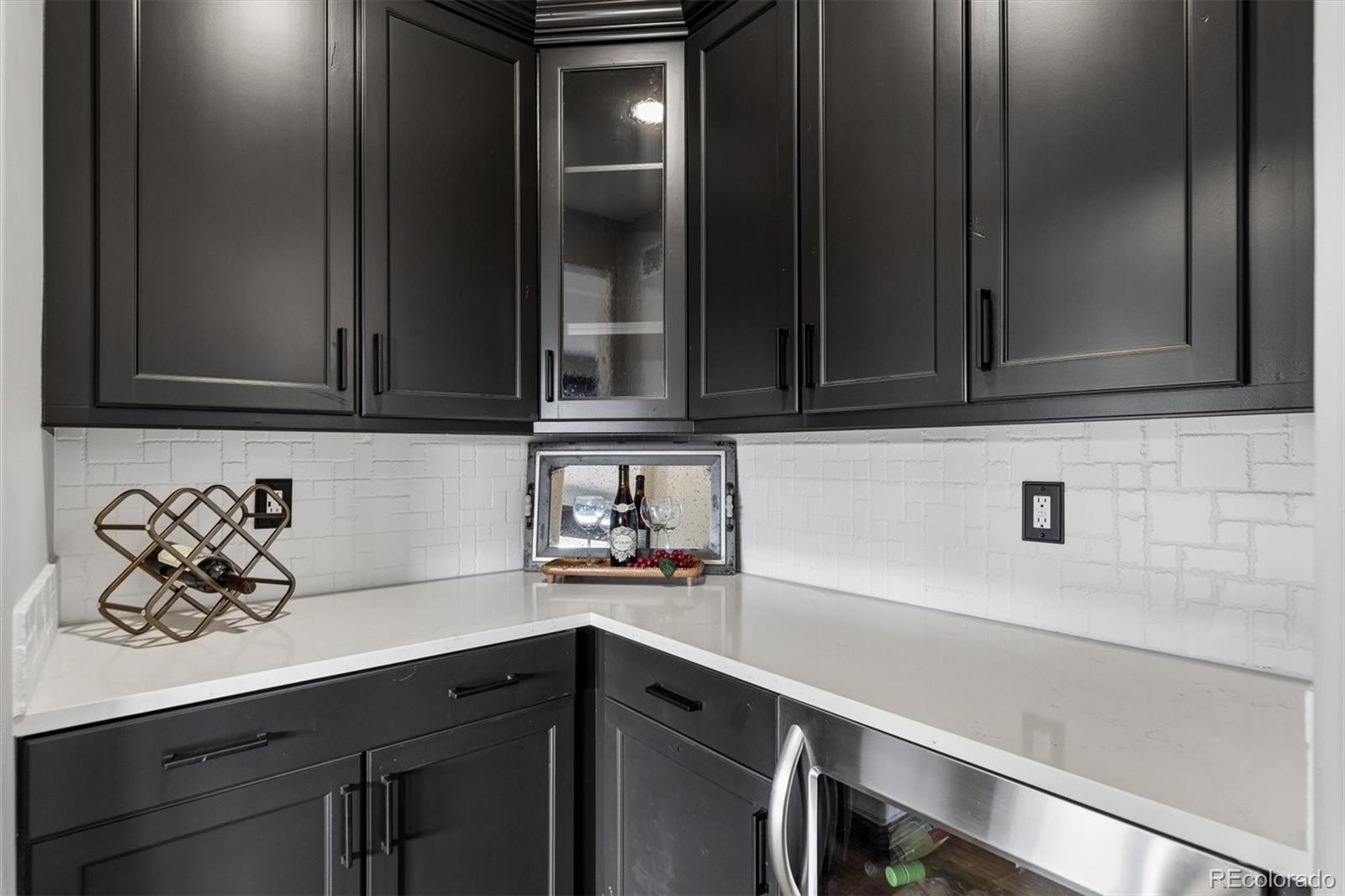 4698 Bandera Place Parker, CO 80134 - Photo 19 of 43 a kitchen with a sink and cabinets