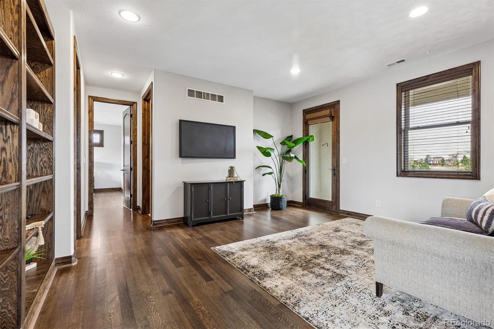4698 Bandera Place Parker, CO 80134 - Photo 23 of 43 a living room with furniture and a flat screen tv