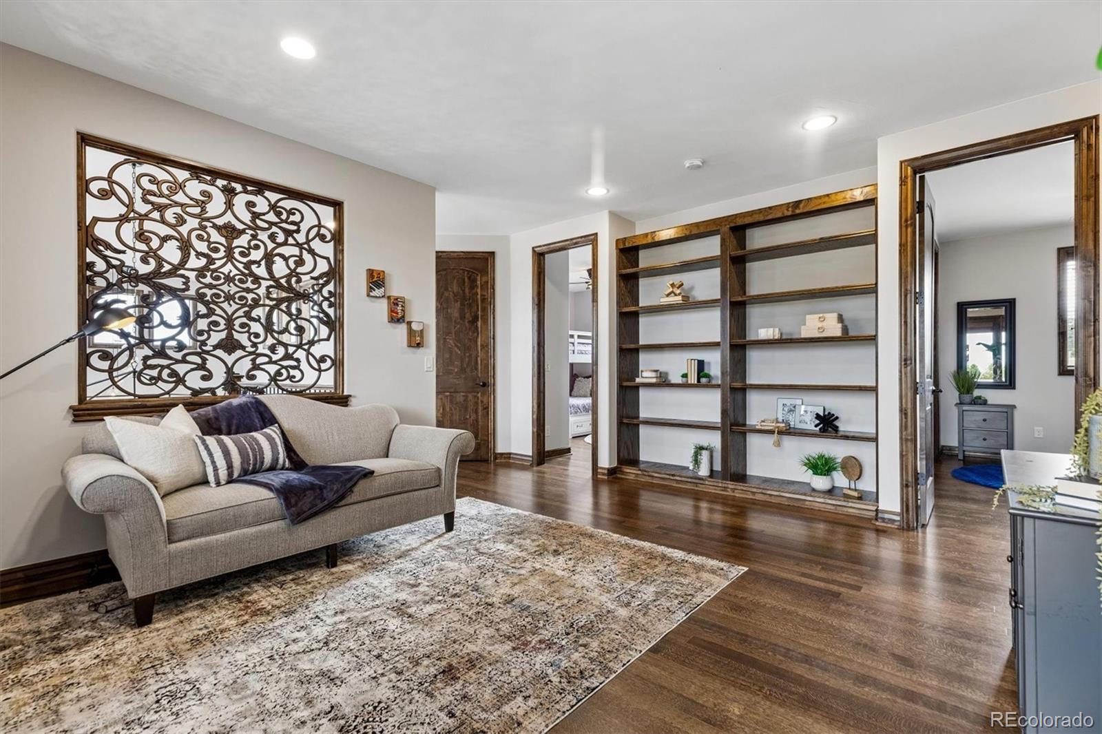 4698 Bandera Place Parker, CO 80134 - Photo 24 of 43 a living room with furniture and wooden floor