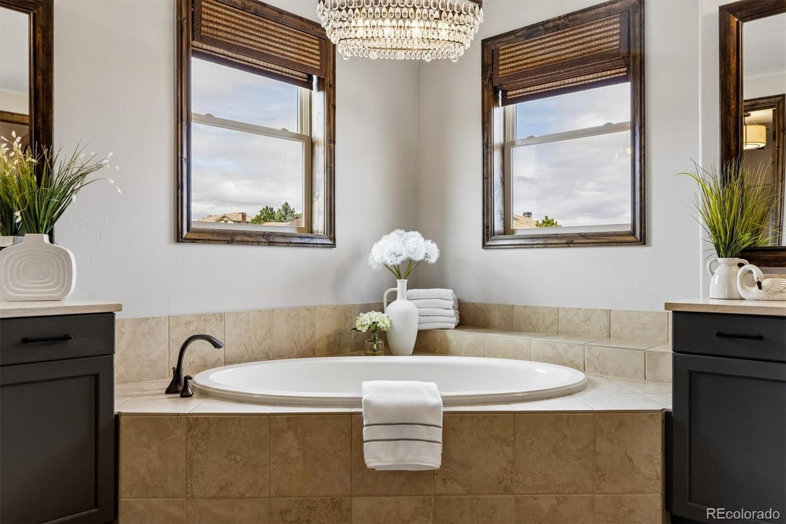 4698 Bandera Place Parker, CO 80134 - Photo 27 of 43 a bathroom with a tub sink and mirror