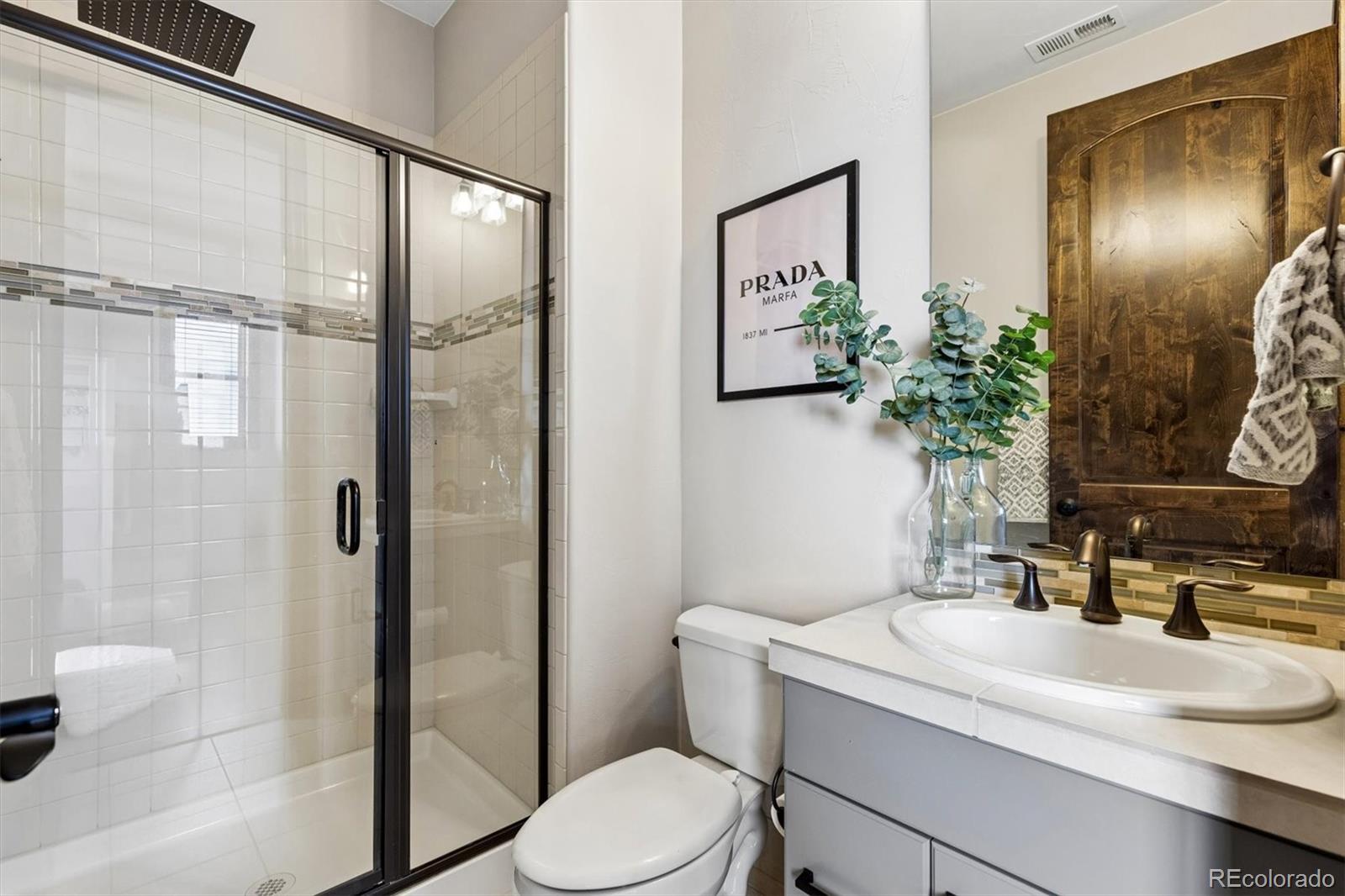 4698 Bandera Place Parker, CO 80134 - Photo 31 of 43 a bathroom with a sink a toilet and shower