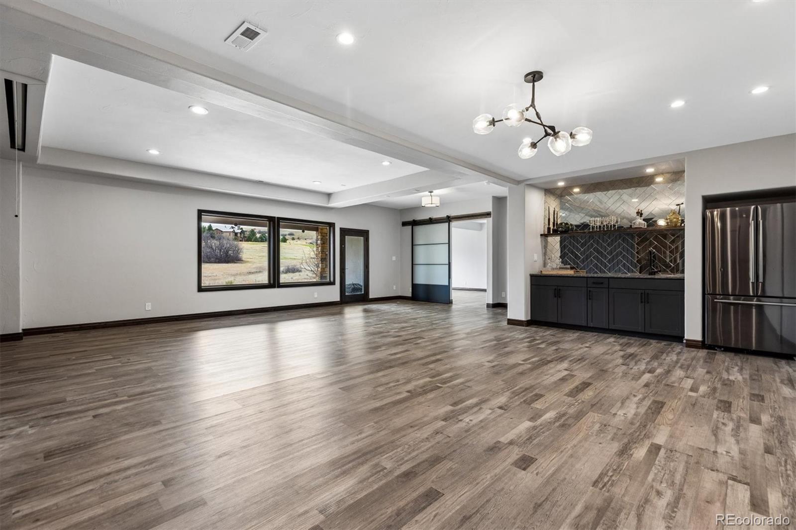 4698 Bandera Place Parker, CO 80134 - Photo 32 of 43 a view of an empty room with a window and wooden floor
