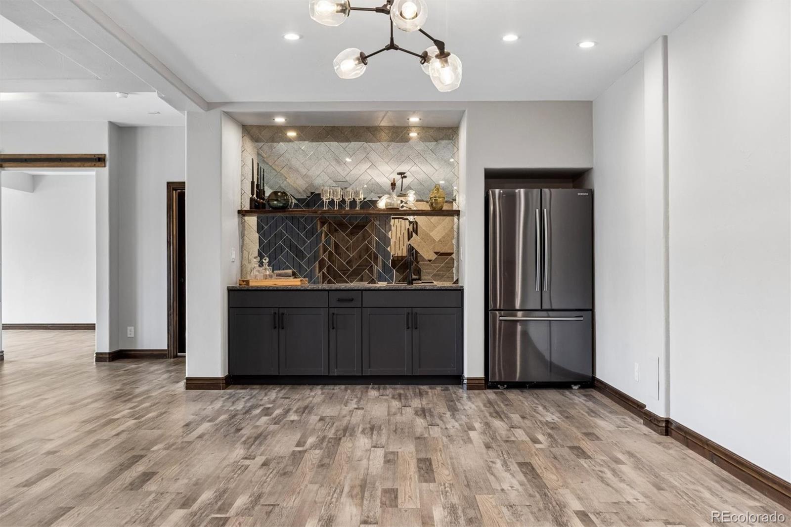 4698 Bandera Place Parker, CO 80134 - Photo 33 of 43 a view of a kitchen with a refrigerator and wooden floor