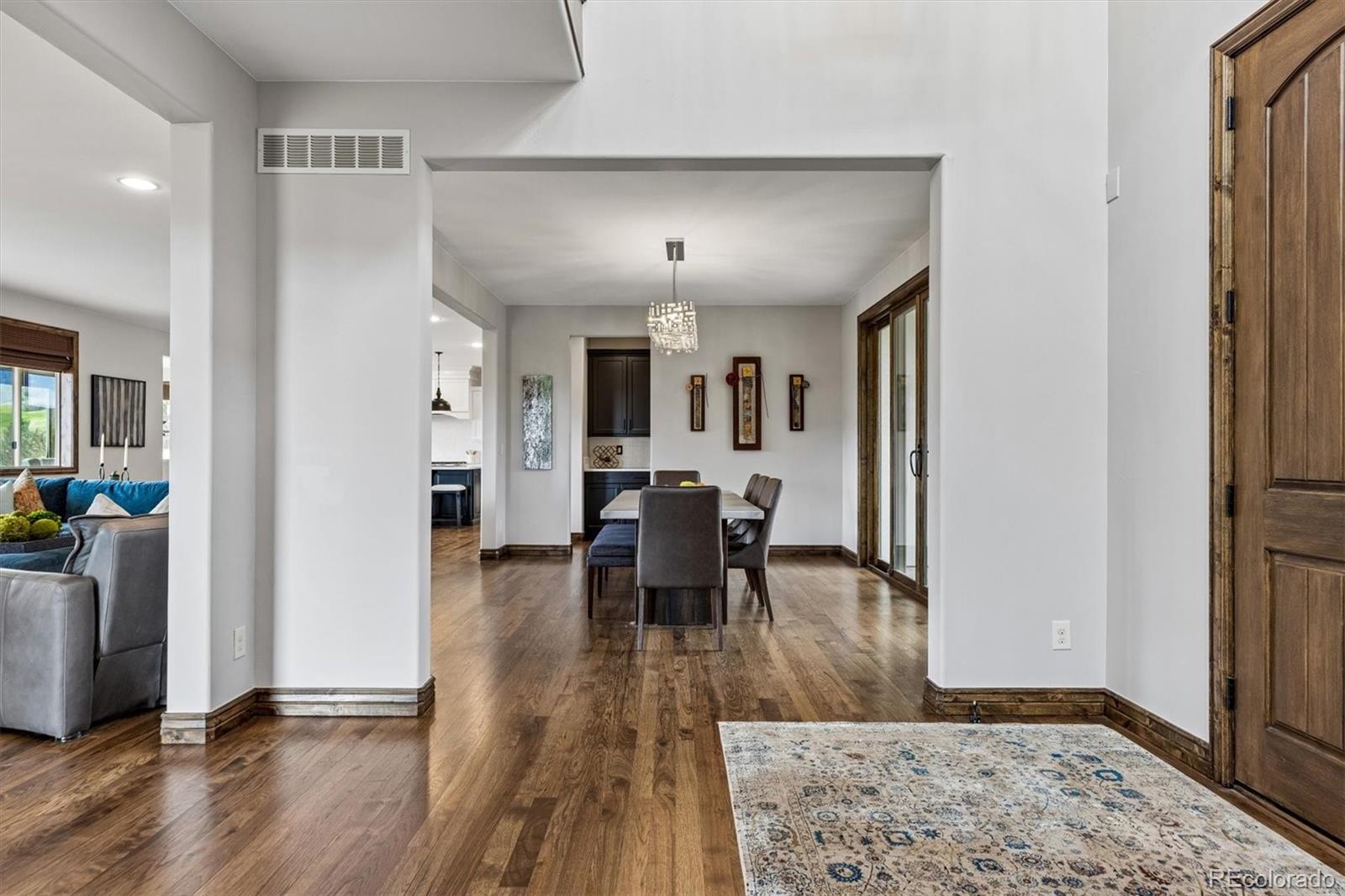 4698 Bandera Place Parker, CO 80134 - Photo 6 of 43 a view of a dining room with furniture and wooden floor