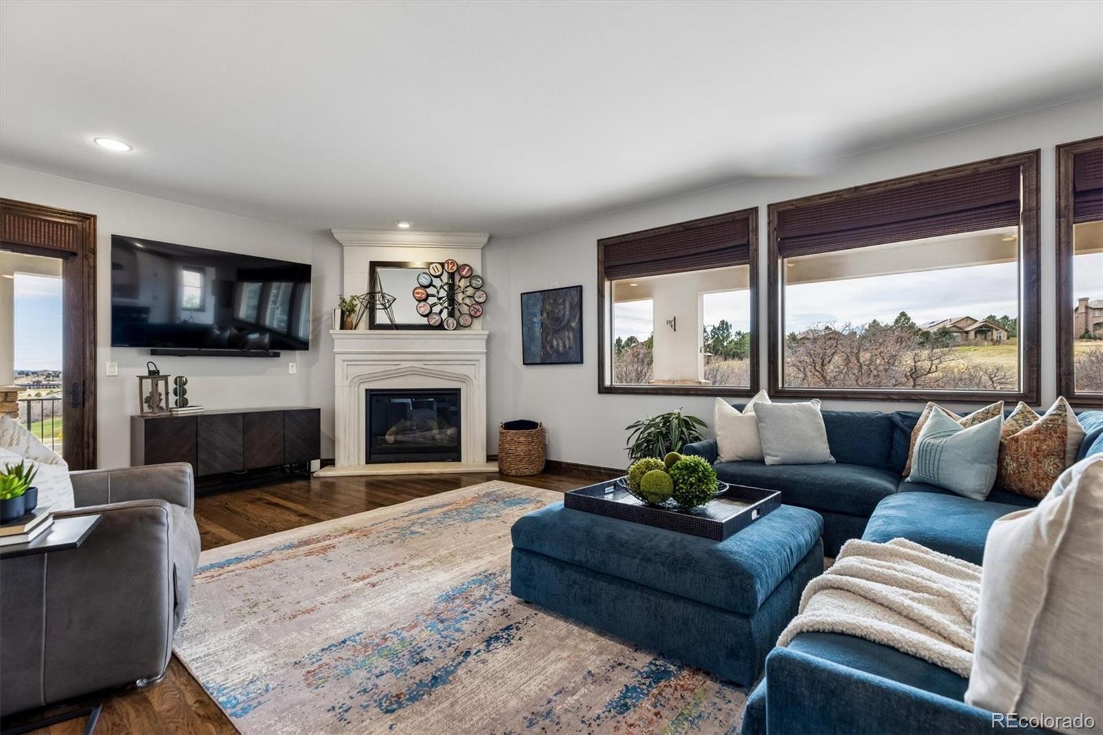 4698 Bandera Place Parker, CO 80134 - Photo 10 of 43 a living room with furniture a large window and a fireplace