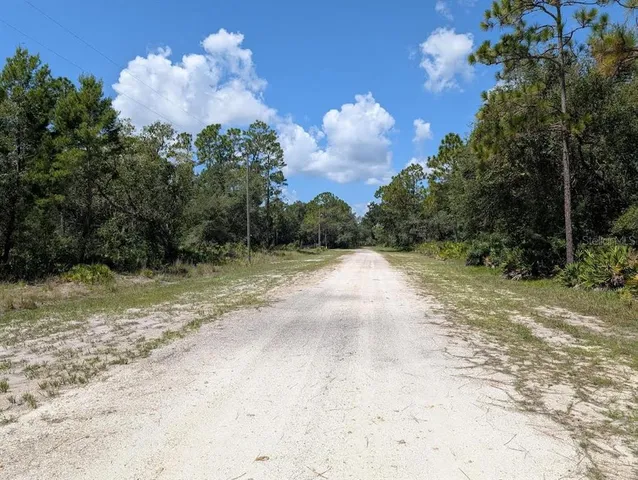 a view of a street with a yard