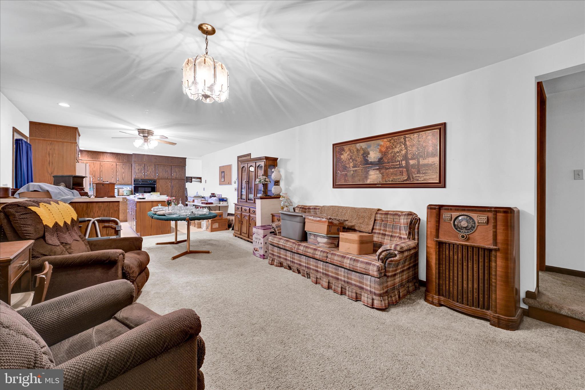 91 Williams Road Myerstown, PA 17067 - Photo 16 of 40 a living room with furniture a chandelier and a flat screen tv