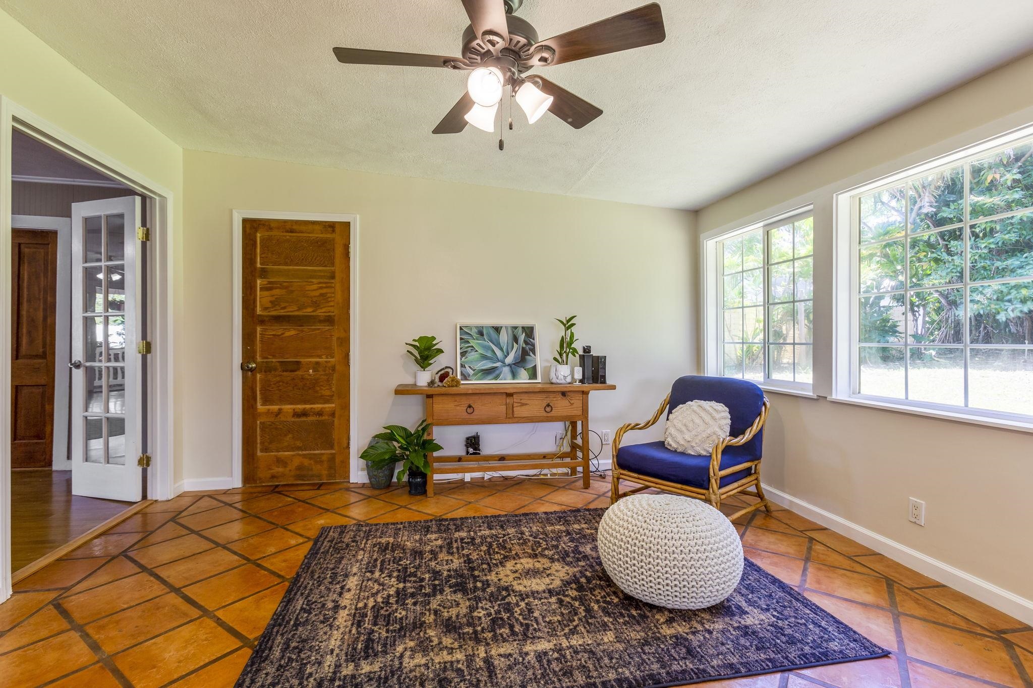 815 Kuulei Street Haiku, HI 96708 - Photo 13 of 25 a bedroom with a bed and wooden floor