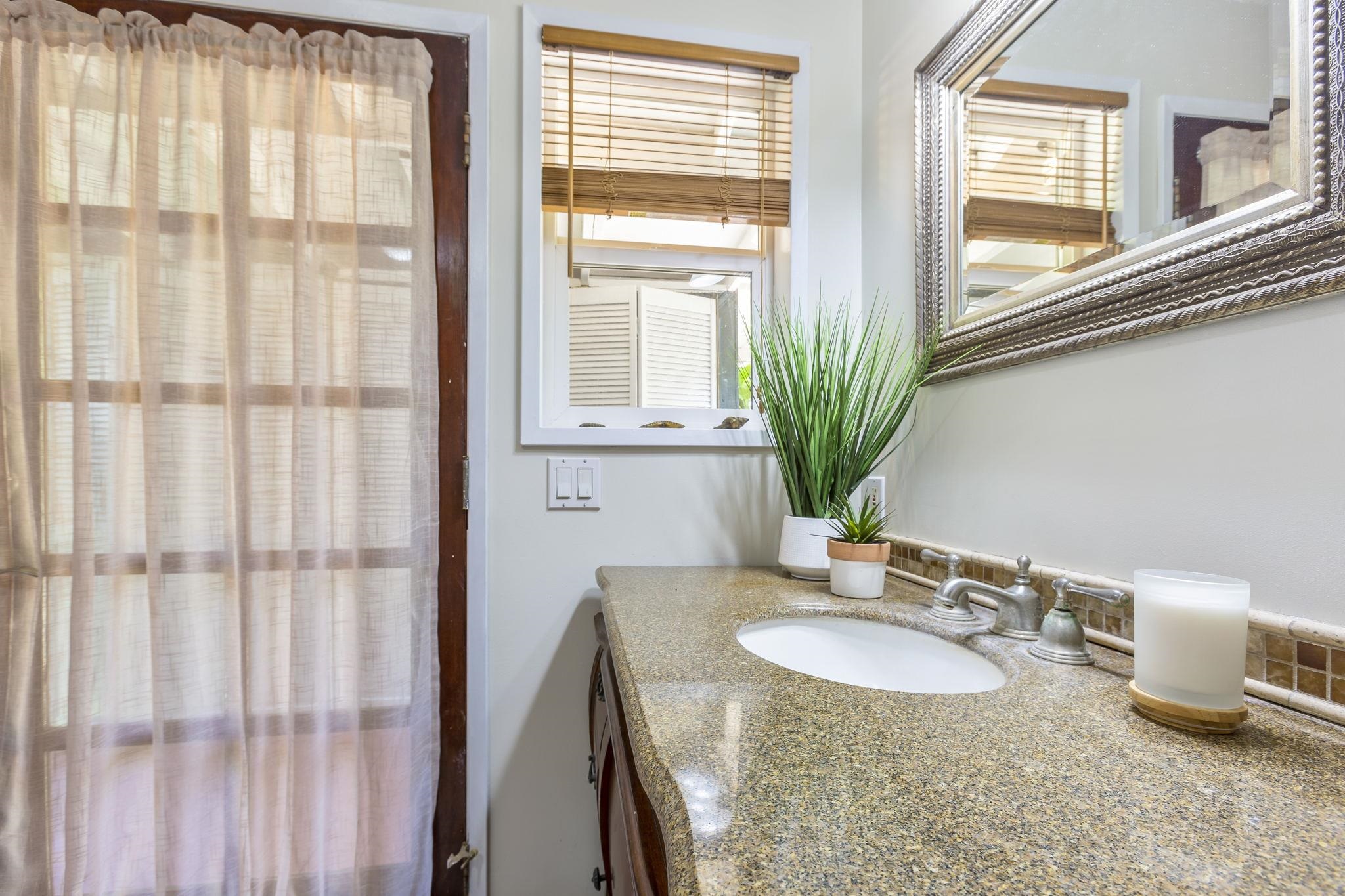 815 Kuulei Street Haiku, HI 96708 - Photo 16 of 25 a bathroom with a granite countertop sink a mirror and a shower