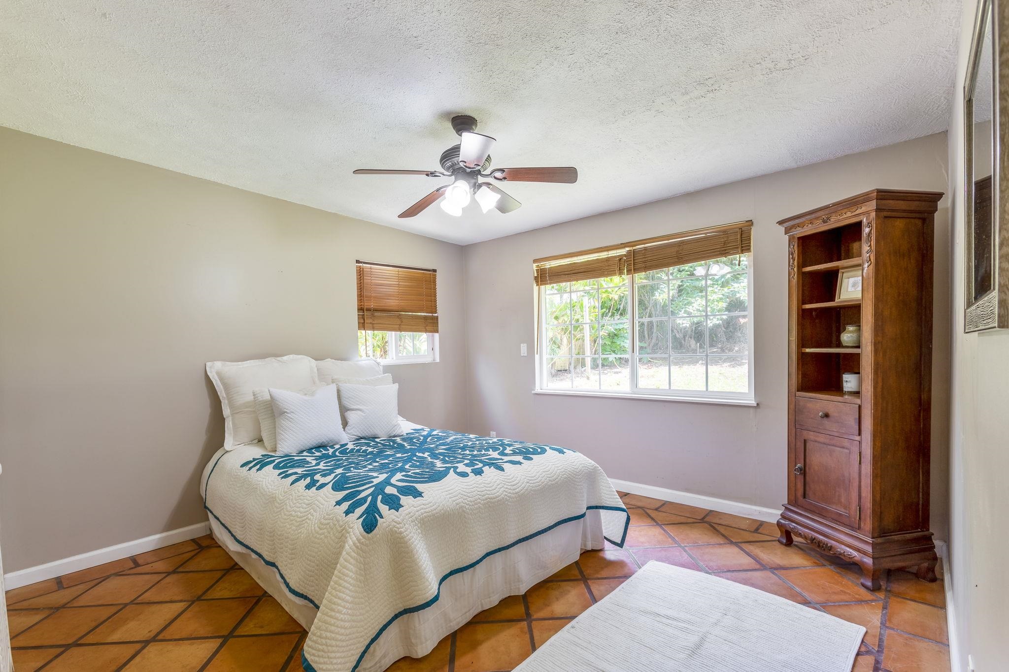 815 Kuulei Street Haiku, HI 96708 - Photo 17 of 25 a bedroom with a bed and a window