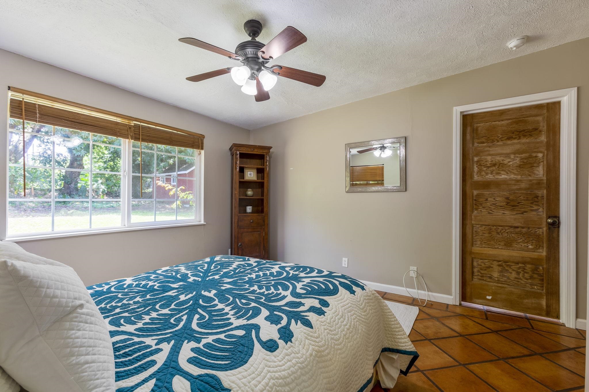815 Kuulei Street Haiku, HI 96708 - Photo 18 of 25 a bedroom with a bed and a window