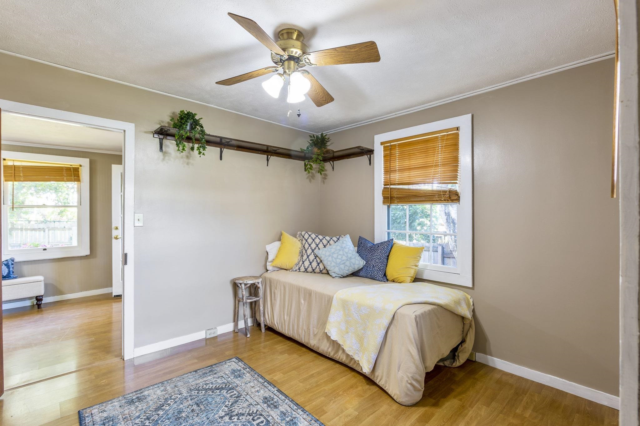 815 Kuulei Street Haiku, HI 96708 - Photo 8 of 25 a bedroom with a bed couch and a window