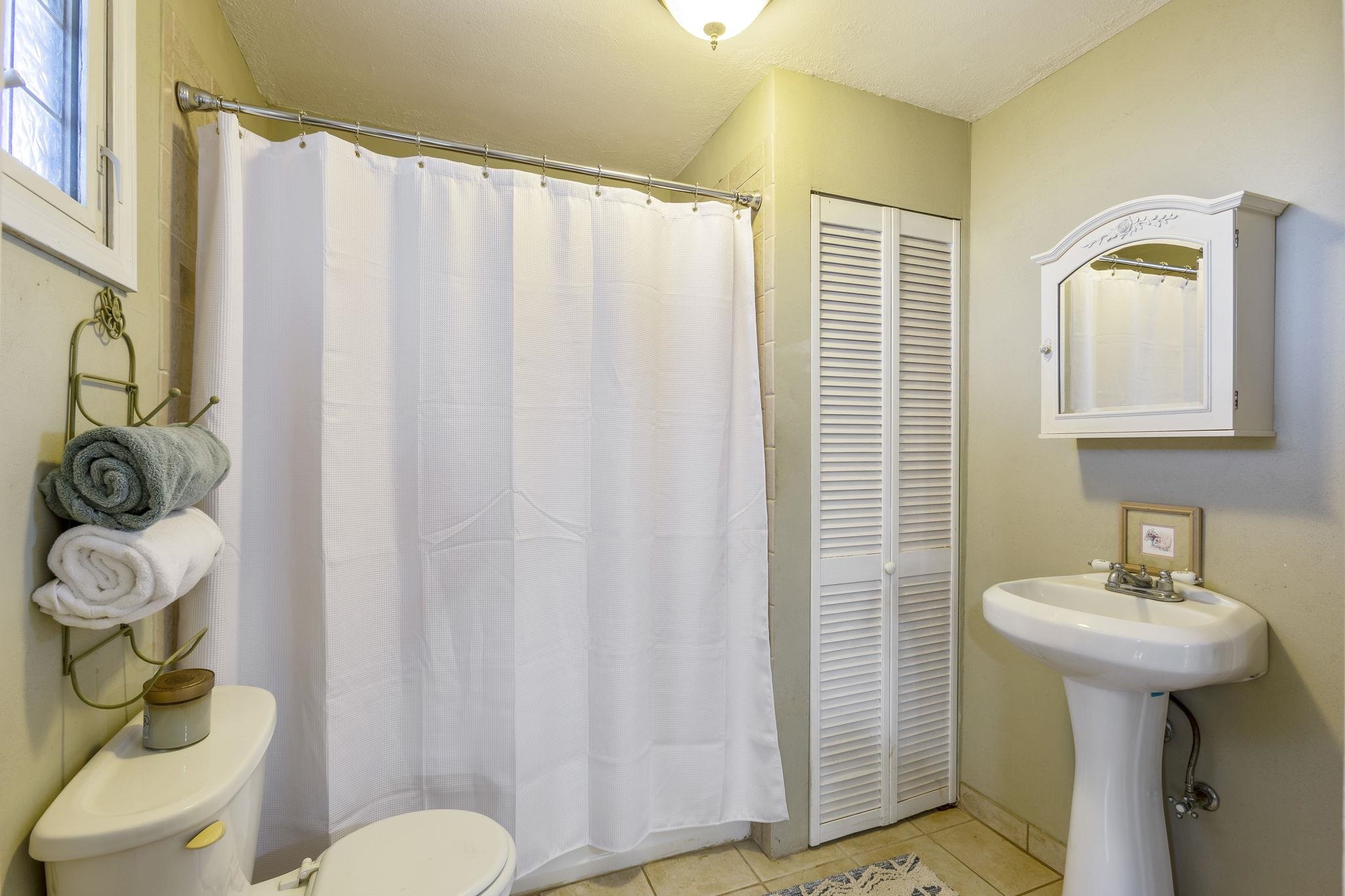 815 Kuulei Street Haiku, HI 96708 - Photo 10 of 25 a bathroom with a sink a toilet and a mirror
