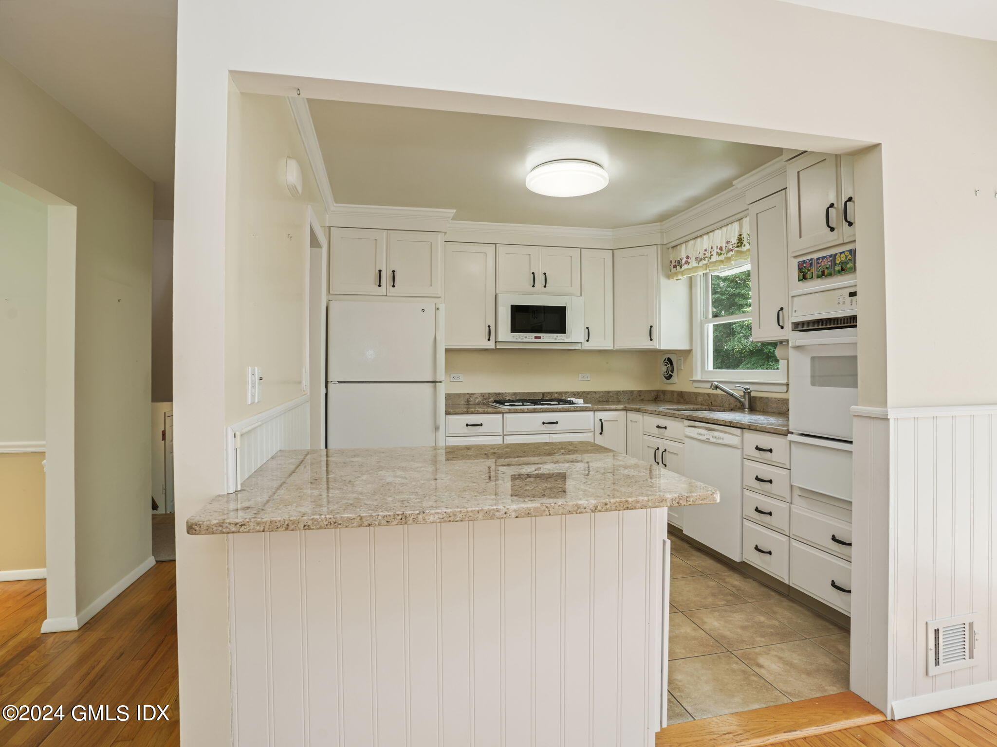 28 Dandy Drive Cos Cob, CT 06807 - Photo 11 of 35 a kitchen with stainless steel appliances granite countertop a stove a sink and a refrigerator