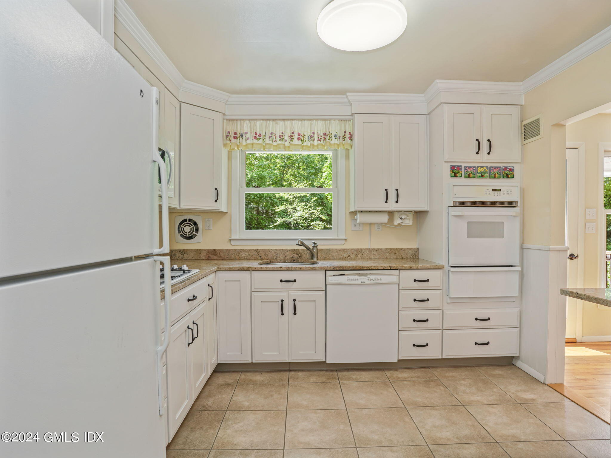 28 Dandy Drive Cos Cob, CT 06807 - Photo 12 of 35 a kitchen with white cabinets and window
