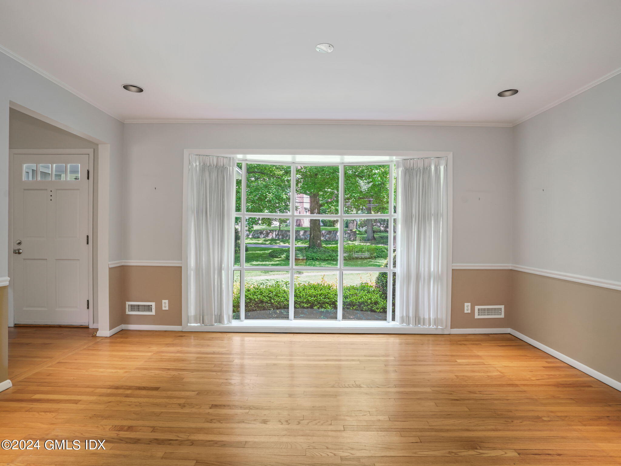 28 Dandy Drive Cos Cob, CT 06807 - Photo 14 of 35 a view of an empty room with wooden floor and a window