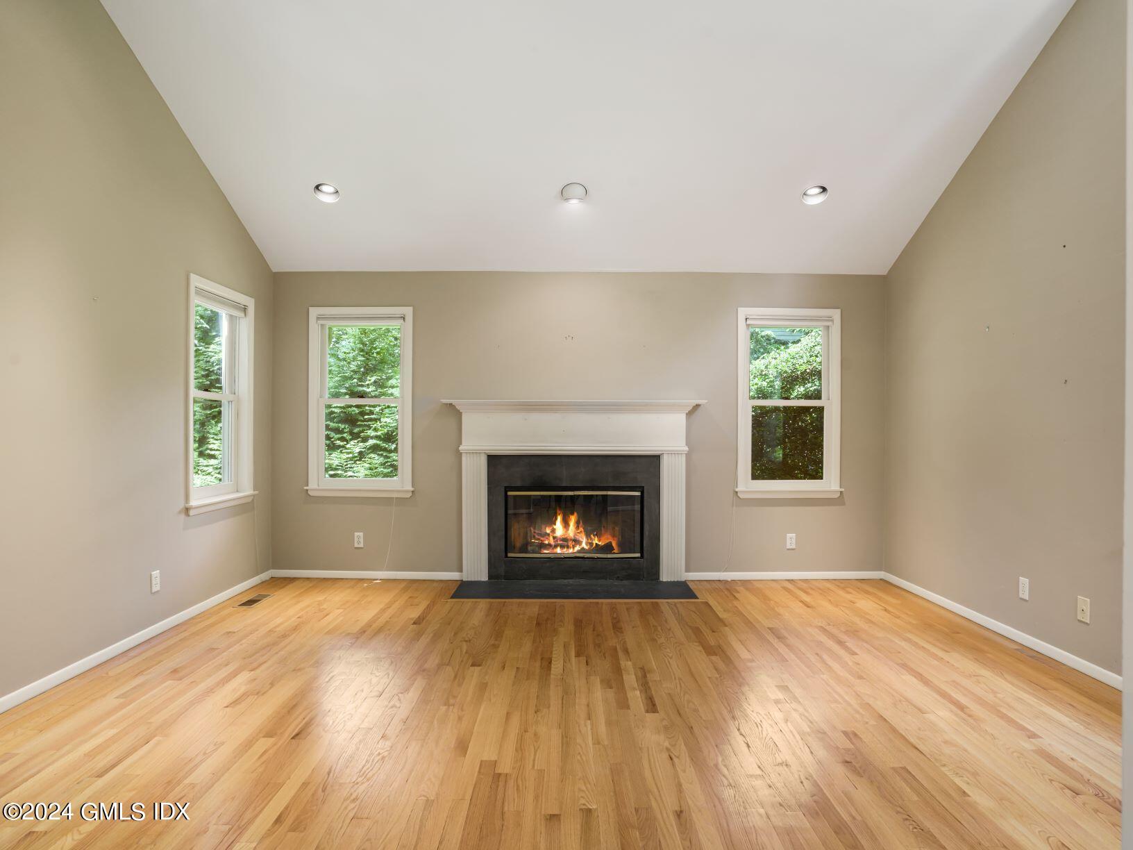 28 Dandy Drive Cos Cob, CT 06807 - Photo 3 of 35 a view of an empty room with a window and a fireplace