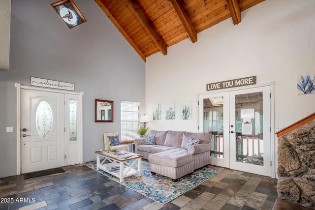 a living room with furniture a rug and a chandelier