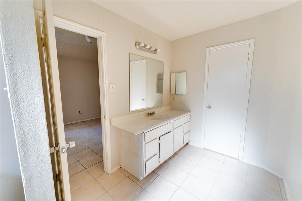 1539 Stevenage Lane Channelview, TX 77530 - Photo 2 of 15 a bathroom with a sink a mirror and a vanity