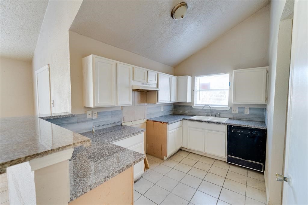 1539 Stevenage Lane Channelview, TX 77530 - Photo 4 of 15 a kitchen with granite countertop a sink a stove top oven and cabinets
