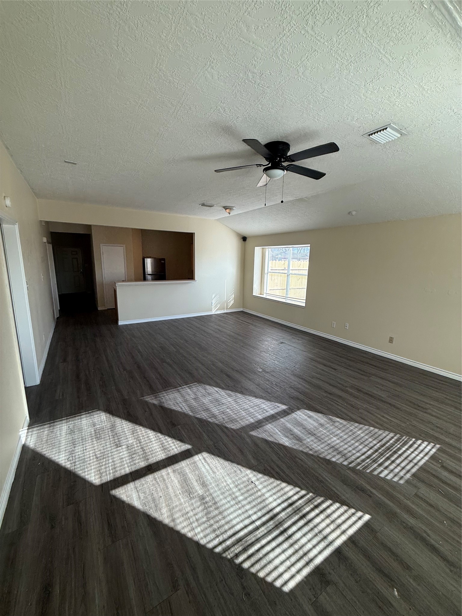 10918 Jutland Road Houston, TX 77048 - Photo 4 of 11 a view of an empty room with window and wooden floor