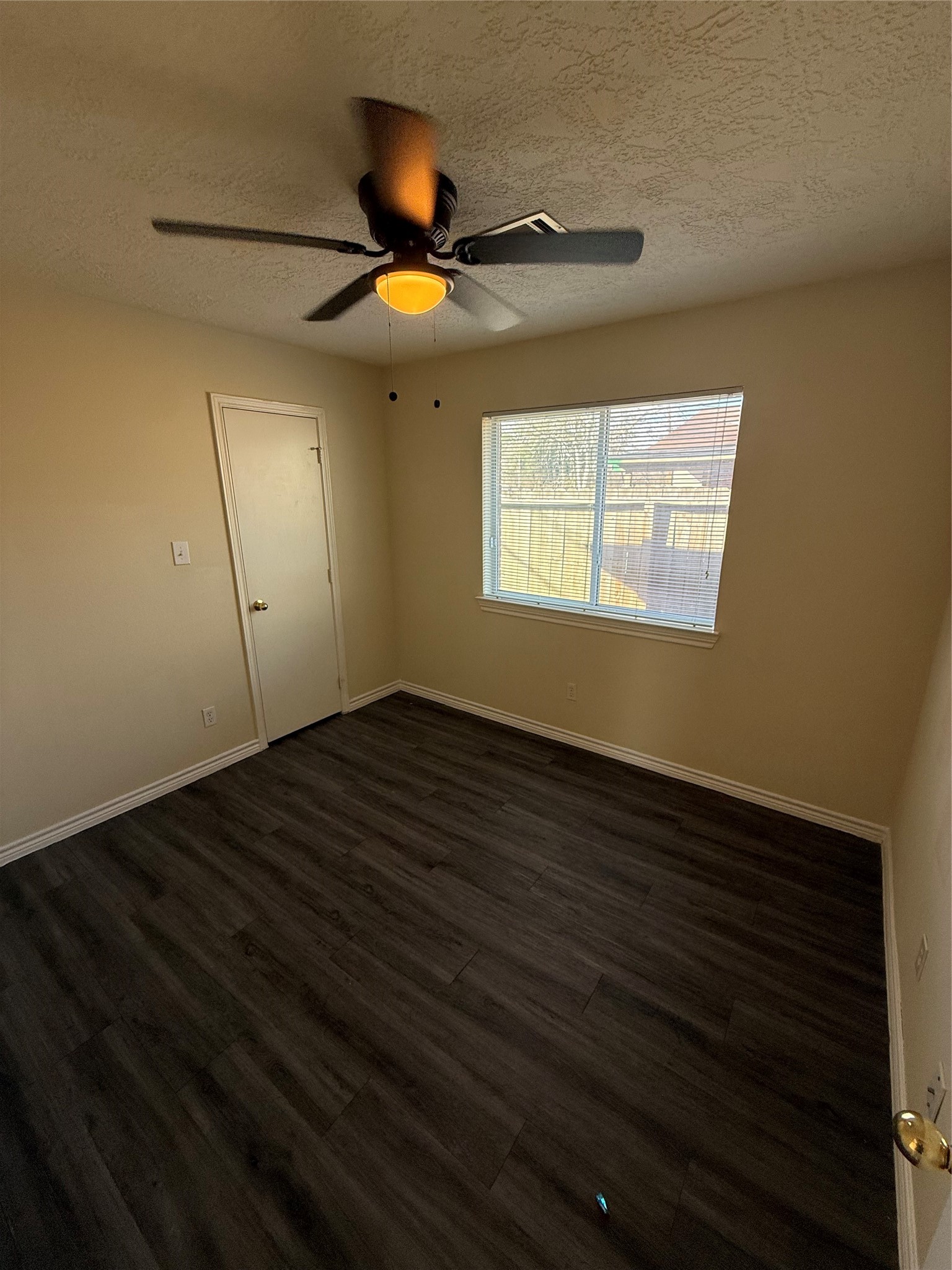 10918 Jutland Road Houston, TX 77048 - Photo 8 of 11 a view of an empty room with wooden floor and a window