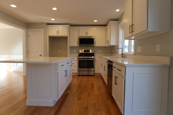 1 Fox Hill Road Ashland, MA 01721 - Photo 2 of 15 a large kitchen with stainless steel appliances granite countertop a stove a sink and a refrigerator
