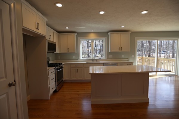 1 Fox Hill Road Ashland, MA 01721 - Photo 3 of 15 a kitchen with stainless steel appliances granite countertop a refrigerator a sink dishwasher a stove and a microwave oven on the wooden floor
