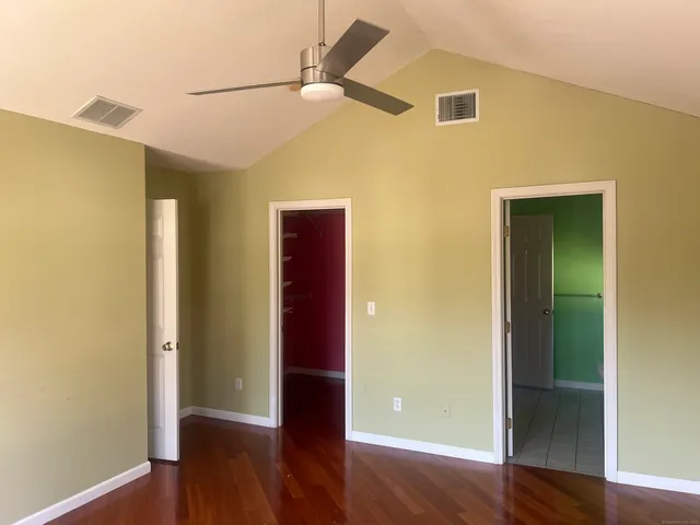 a view of empty room with wooden floor