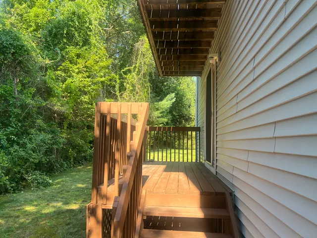 a view of balcony with wooden floor and fence