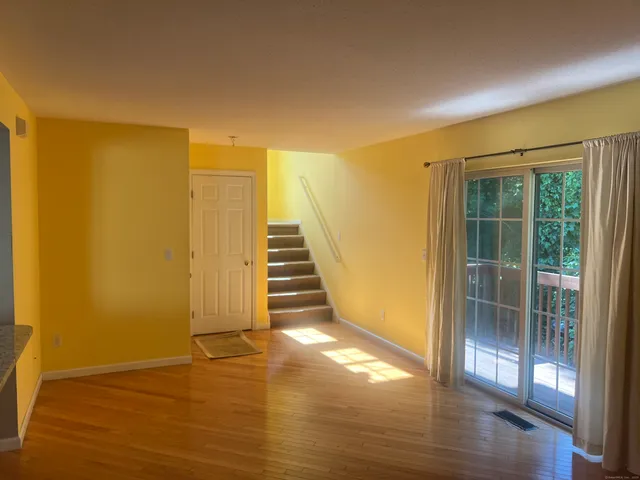 a view of a room with wooden floor and brick walls