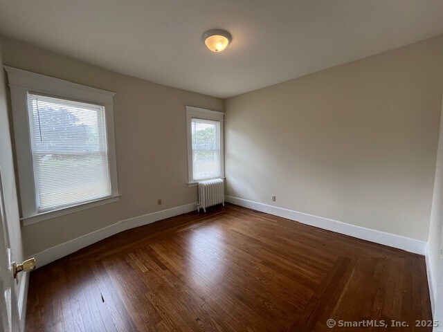1946 Chapel Street New Haven, CT 06515 - Photo 18 of 18 an empty room with wooden floor and windows