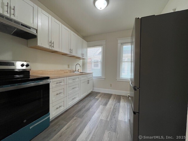 1946 Chapel Street New Haven, CT 06515 - Photo 8 of 18 a kitchen with a sink dishwasher a stove and a refrigerator