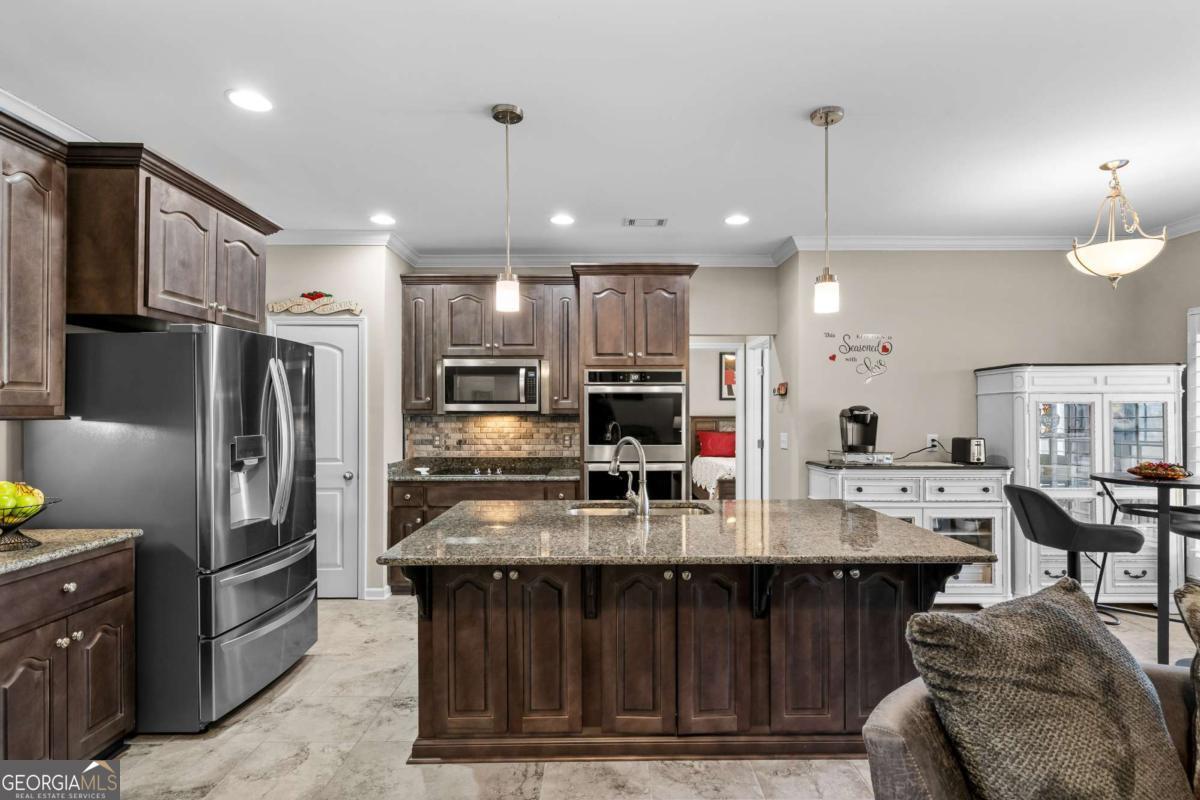 96 Morgan Trail, Unit 15R Ellijay, GA 30536 - Photo 24 of 42 a kitchen with stainless steel appliances kitchen island granite countertop a refrigerator and a stove top oven