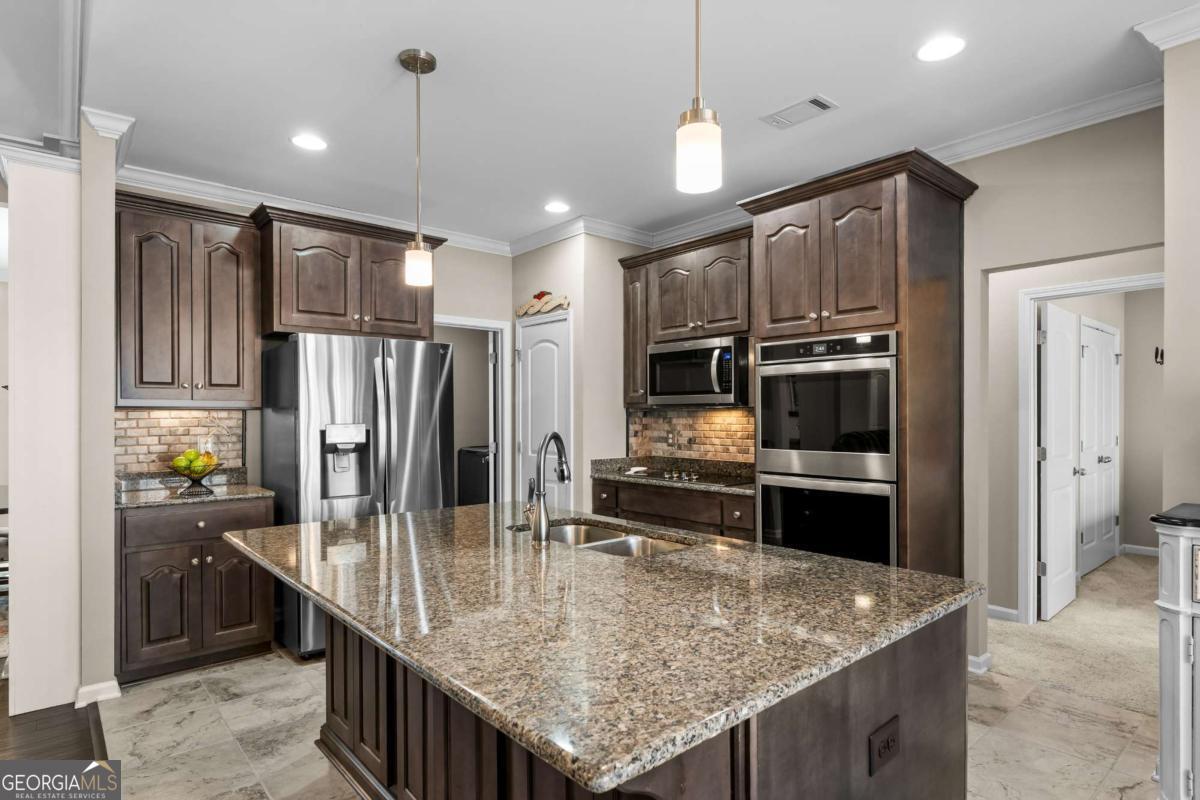 96 Morgan Trail, Unit 15R Ellijay, GA 30536 - Photo 25 of 42 a kitchen with stainless steel appliances granite countertop a sink a stove and refrigerator