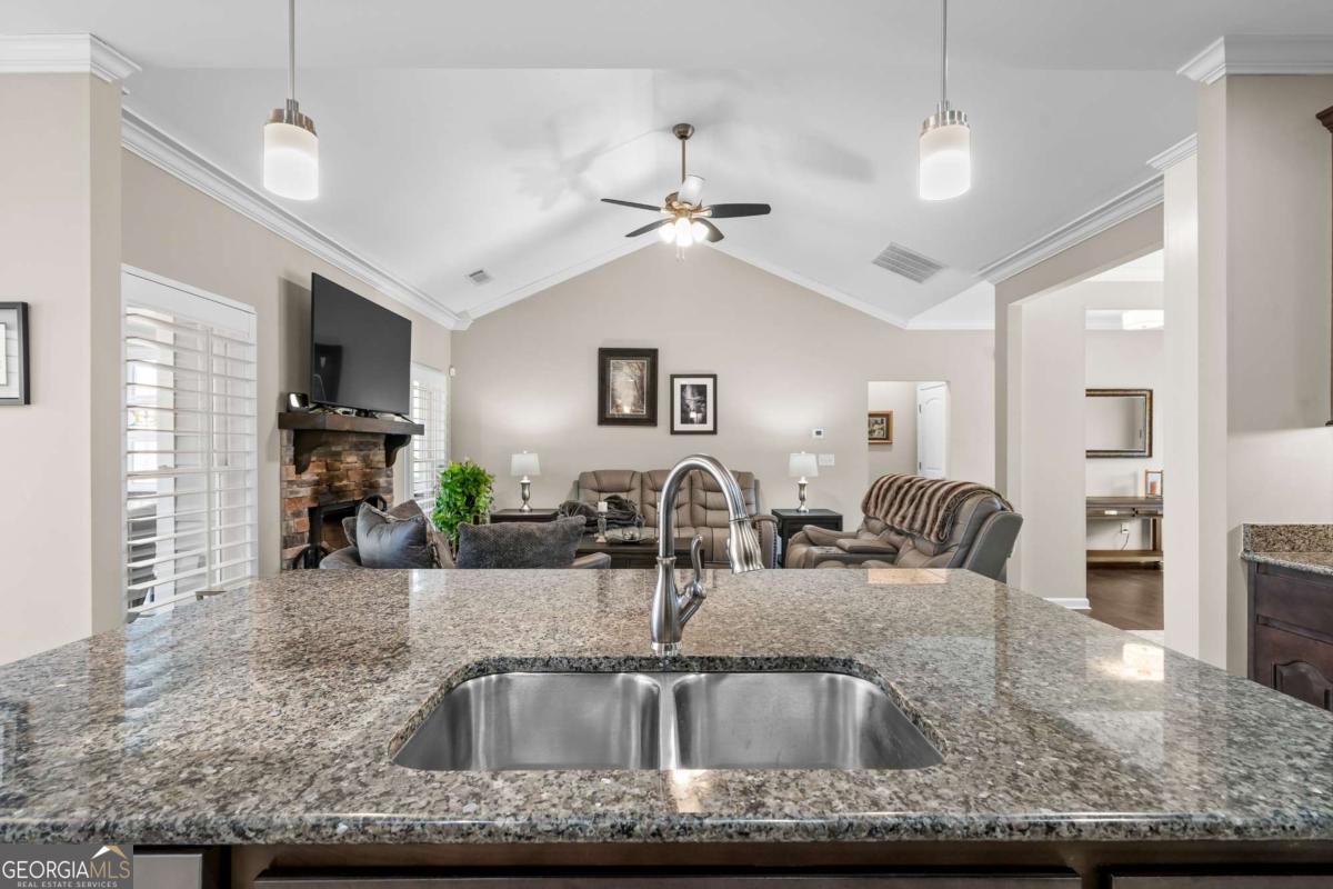 96 Morgan Trail, Unit 15R Ellijay, GA 30536 - Photo 27 of 42 a kitchen with granite countertop a sink a counter top space cabinets and stainless steel appliances