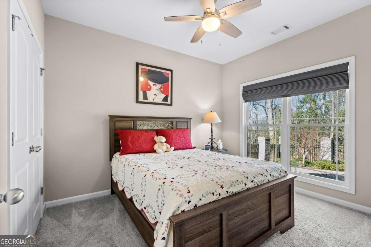 96 Morgan Trail, Unit 15R Ellijay, GA 30536 - Photo 37 of 42 a bedroom with a large bed and a chandelier