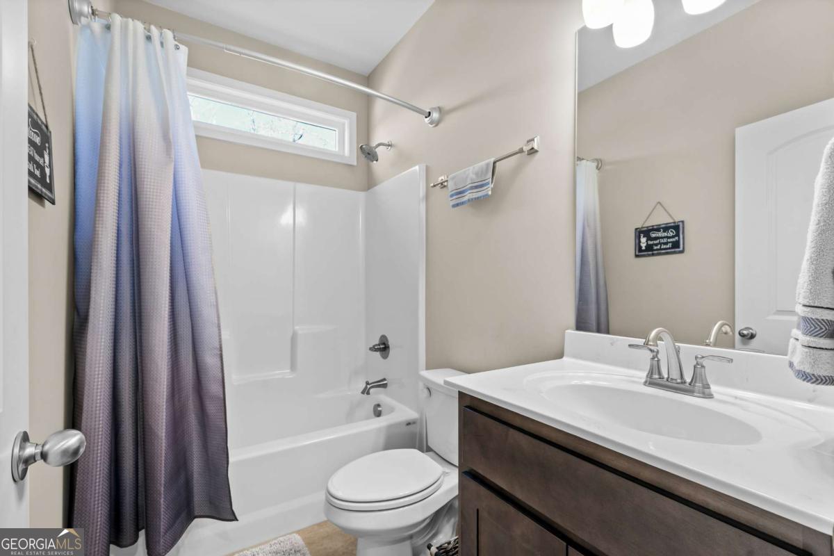 96 Morgan Trail, Unit 15R Ellijay, GA 30536 - Photo 39 of 42 a bathroom with a granite countertop sink toilet and shower