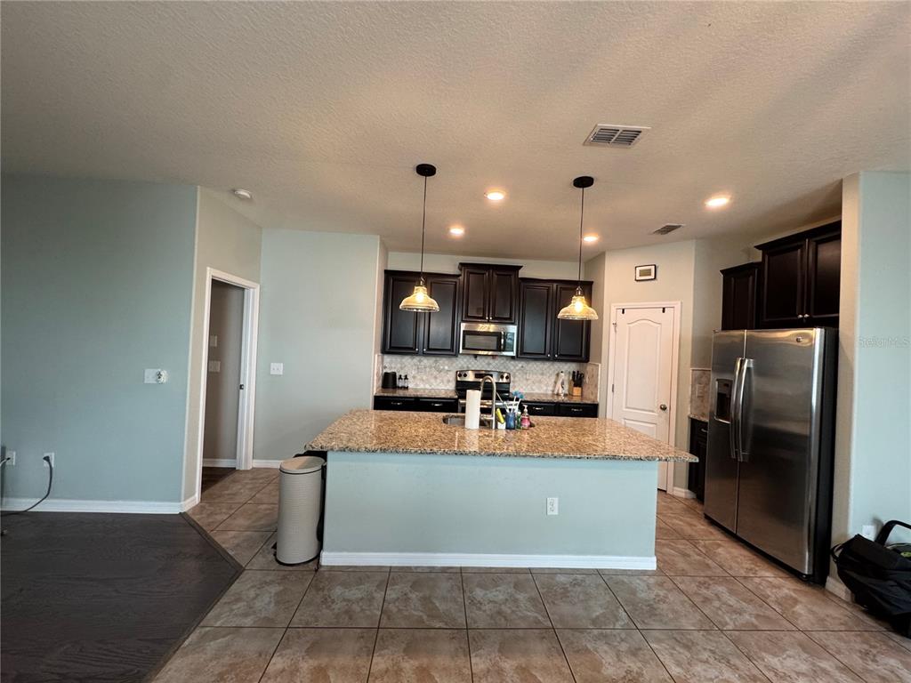 11832 Lake Boulevard New Port Richey, FL 34655 - Photo 12 of 58 a large kitchen with a large counter top stainless steel appliances and a counter top space