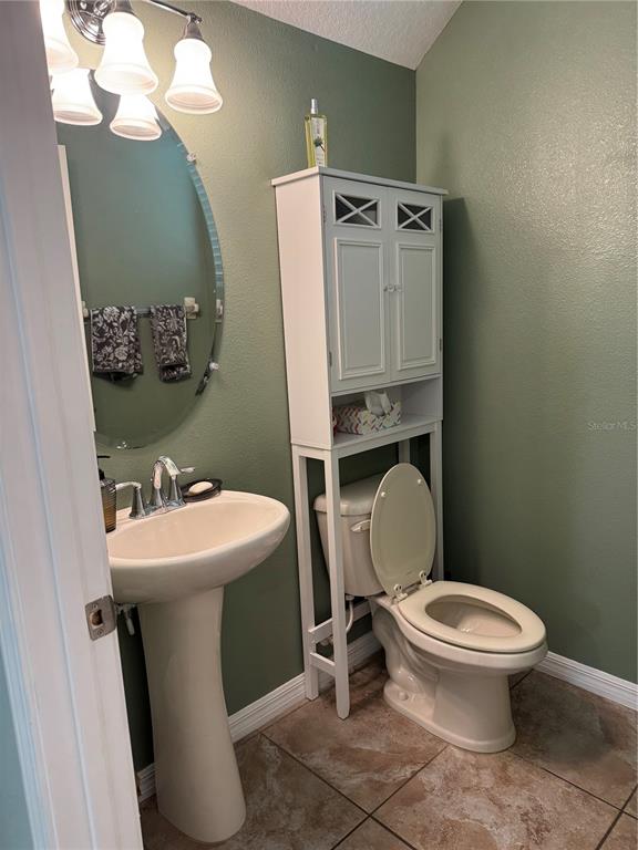 11832 Lake Boulevard New Port Richey, FL 34655 - Photo 19 of 58 a white toilet sitting next to a bathroom sink