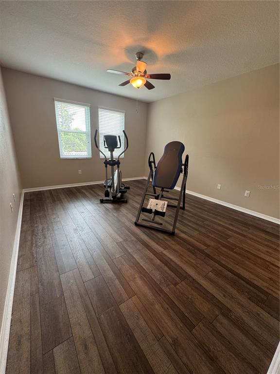 11832 Lake Boulevard New Port Richey, FL 34655 - Photo 21 of 58 a view of workspace with wooden floor windows gym equipment