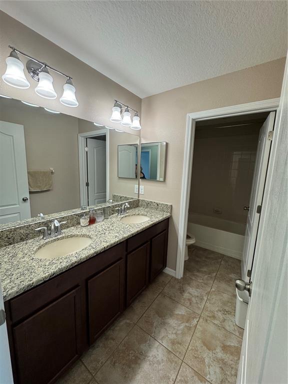 11832 Lake Boulevard New Port Richey, FL 34655 - Photo 30 of 58 a bathroom with a granite countertop sink mirror and a