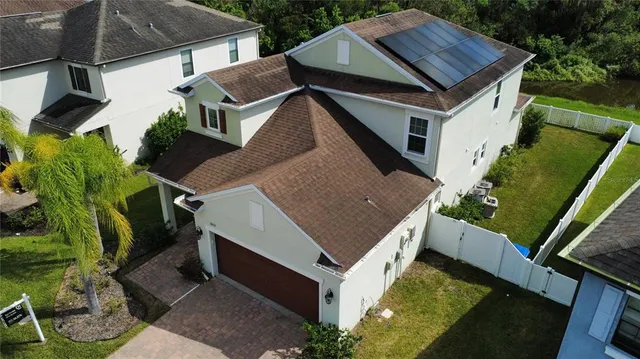 a aerial view of a house with a yard