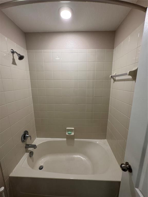 11832 Lake Boulevard New Port Richey, FL 34655 - Photo 32 of 58 a bathroom with a bathtub