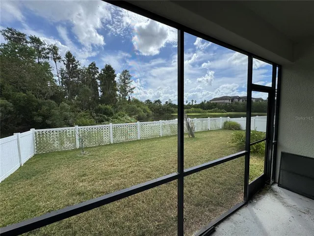 a view of a lake and houses in the back